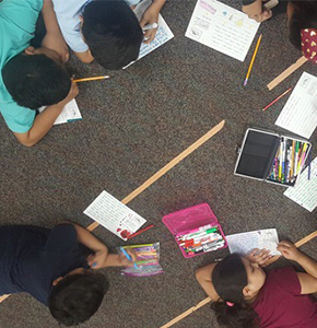 Group of students working together on the classroom floor